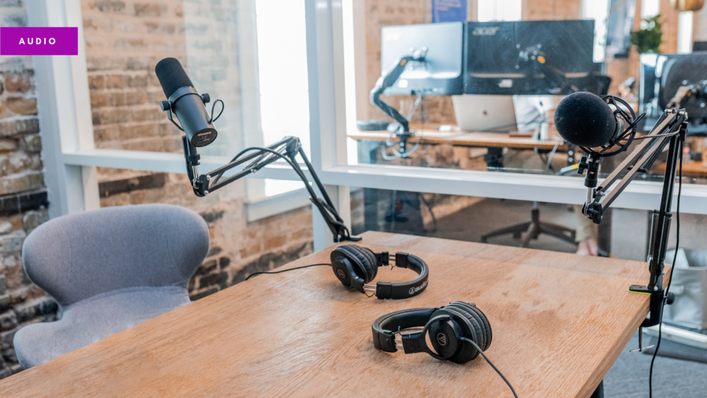 A photograph of a man presenting during an online Zoom meeting, wearing headphones. Image by Getty Images Pro