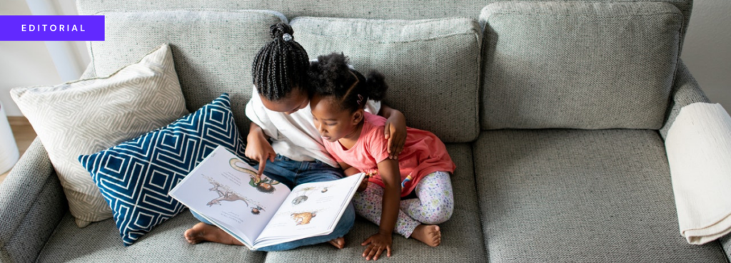 header image showing two girls reading a book on a sofa