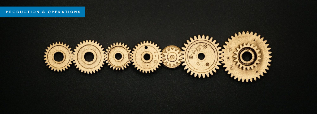 Seven interlocking gold coloured metal cogs in a row